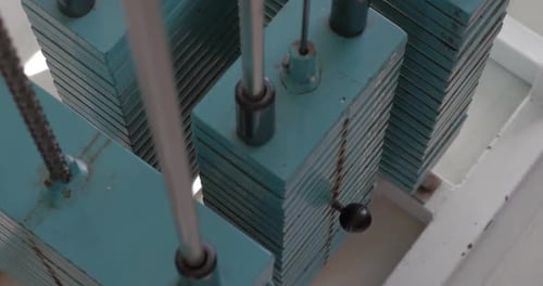 Hand Selecting Weight On Turquoise Weight Machine