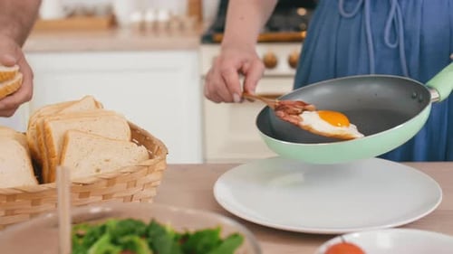 Preparing Eggs, Bacon, and Toast in Kitchen