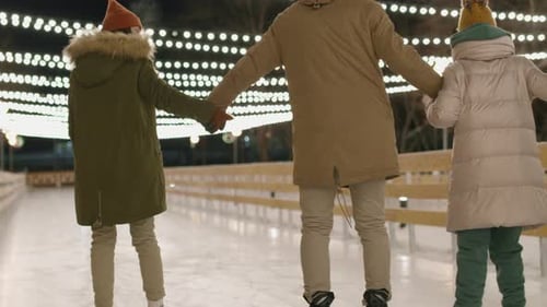 Group Skating Together on an Outdoor Ice Rink