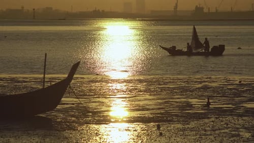 Silhouette Asian fisherman row boat