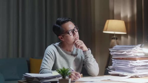 Man Working at Desk Has an Idea