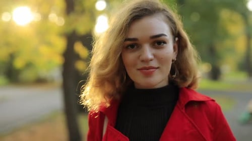 Blonde Woman Smiling in Autumn Park Portrait