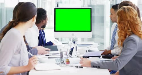 Diverse Team in Meeting with Green Screen Monitor