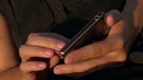 Close Up of Hands Holding Cellphone