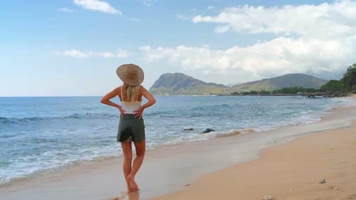Woman walking on the beach 4k