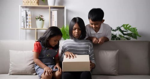 Children Open a Gift with Joyful Excitement