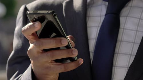 Elegant Businessman Using Smartphone to Send Messages or Email: Cell Phone
