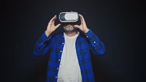 Close Up Shot of the Middle Age Bearded Man Wearing Virtual Reality Goggles and Waving His Hands on