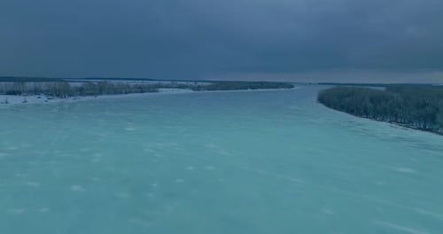 Copter Flies Over the Frozen River White Ice