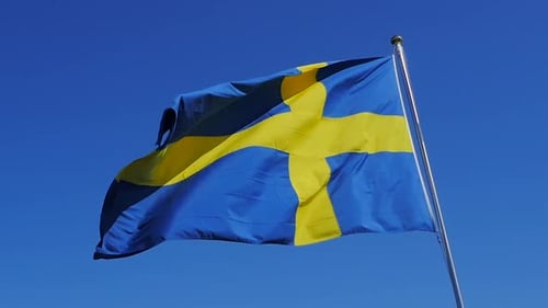 Swedish Flag Waving against Clear Blue Sky