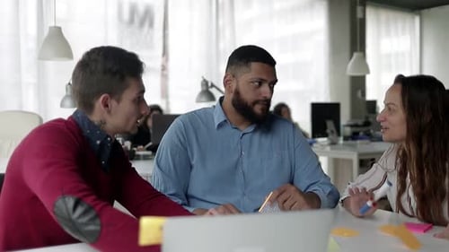 Creative Diverse Team Brainstorming at Table in Office