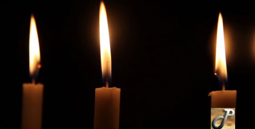 Candle Flames Flicker in the Darkness