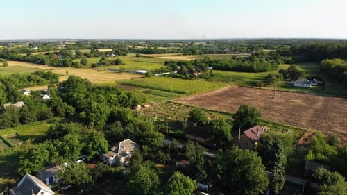 Aerial View of the Countryside and Small Village with Green Fields and Meadows