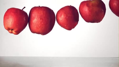 Apples Dropping in Water Tank in Slow Motion