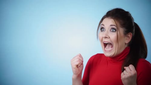 Excited Woman Expressing Joy on Blue Background