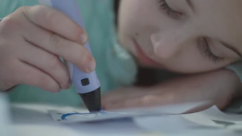 Child Creating 3D Design with Printing Pen