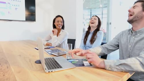 Business Team Laughing at Office Meeting