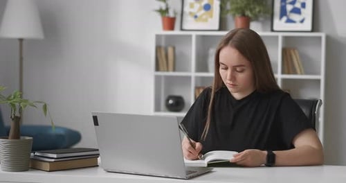 Focused Student Studying with Laptop at Home