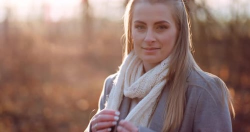 Portrait of Positive Female Walking in Woods in Autumn