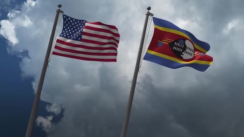 United States and Eswatini Flags Waving Against Cloudy Sky