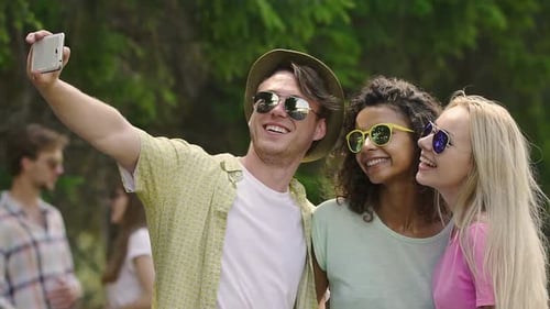 Friends Smiling and Taking Selfie Outdoors
