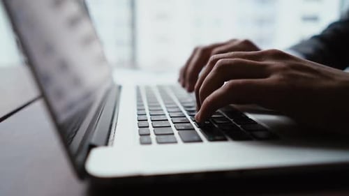 Close-up of Hands of Unrecognizable Businessman Typing on Laptop Keyboard Working at Office Desk