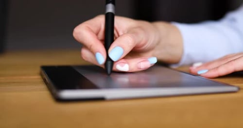 Illustrator hands scetching on tablet computer, using stylus