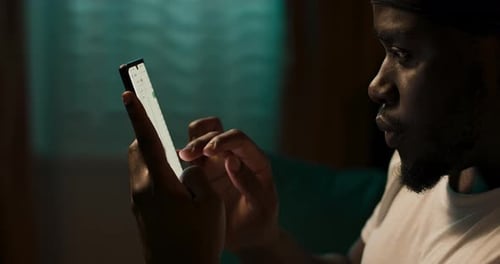 Man Using Bright Mobile Phone at Night