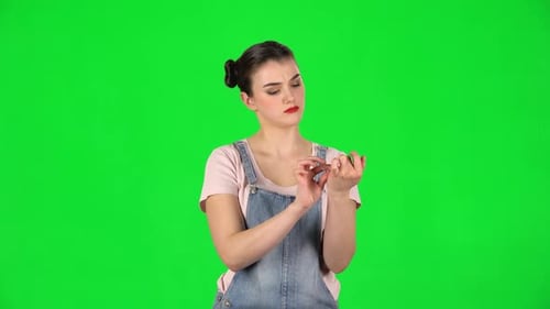 Woman Filing Nails on Green Screen Background
