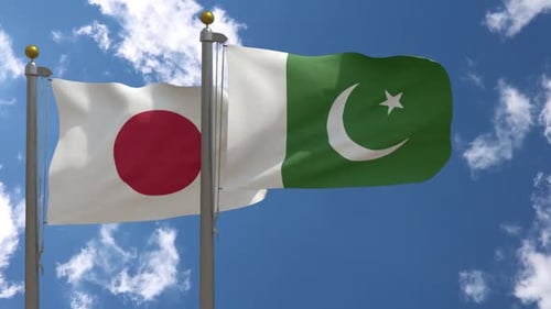 Waving Flags of Japan and Pakistan Against a Blue Sky
