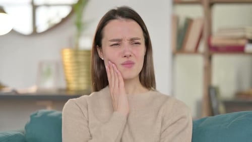 Portrait of Sick Young Woman Having Toothache at Home
