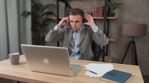 Young Confident Man Wearing Headset, Call Center Agent Consult Business Client Online Using Laptop