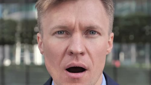 Surprised Man Opens His Mouth Wide in City