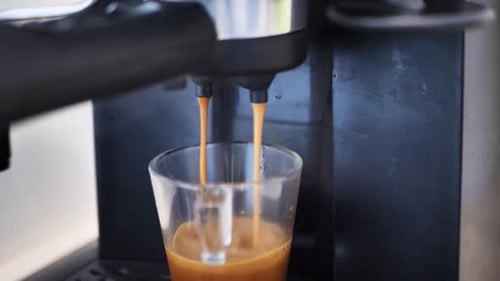 Footage B Roll of Pouring Coffee Stream From Machine in Cup