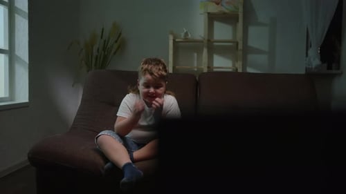 Scared Boy Watching Something on TV at Night