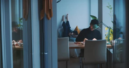Young Adult Relaxed at Desk Working