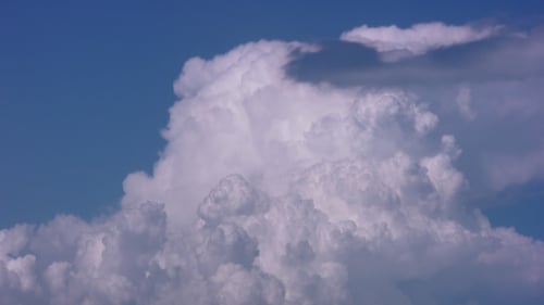 White Clouds Moving Across the Blue Sky