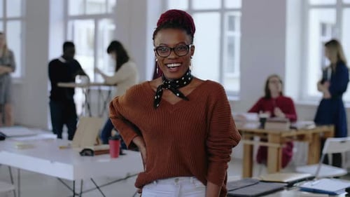 Smiling Woman Poses in Bright Modern Office
