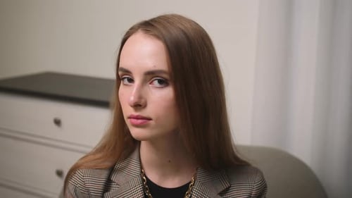 Young Woman in Blazer Looking at Camera