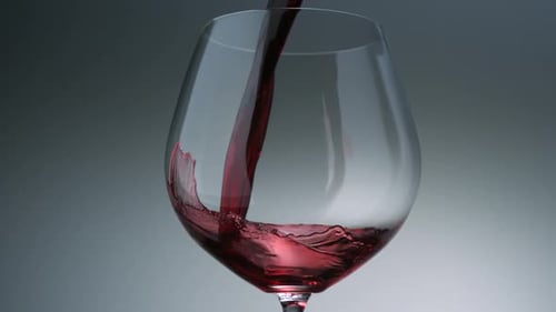 Red Wine Being Poured Into Clear Glass