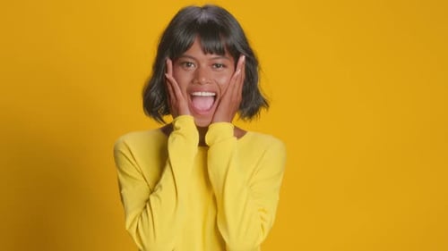 Excited Young Woman Reacts with Joy and Surprise