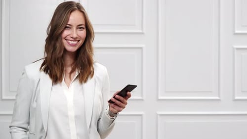 Woman Using Mobile Phone, Smiling Indoors