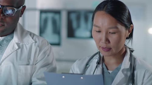 Doctors Examining X-Ray Together in Hospital Setting