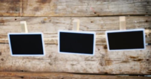 Chalkboard hanging against wooden wall 4k