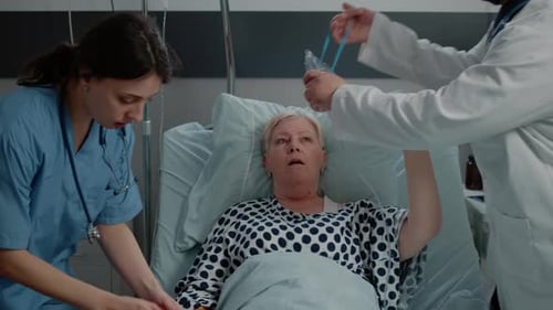 Medical Team Assists Patient With Oxygen Mask