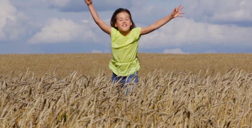 Girl Running in Wheat Field on Sunny Day