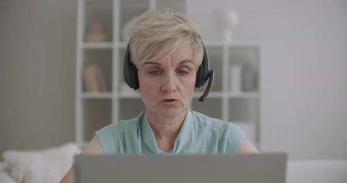Retiree Woman Is Working From Home in Call-center, Phone Sales and Tech Support Department, Remote