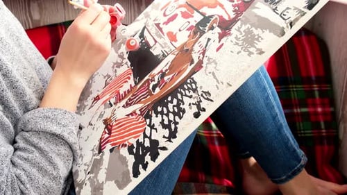 Person Painting a Colorful Picture at Home