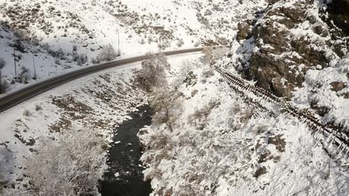 Winter River and Snow-Covered Rocky Mountain Landscape