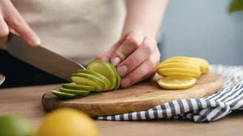 Close up of woman cutting lime in the kitchen. Shot with RED helium camera in 4K.